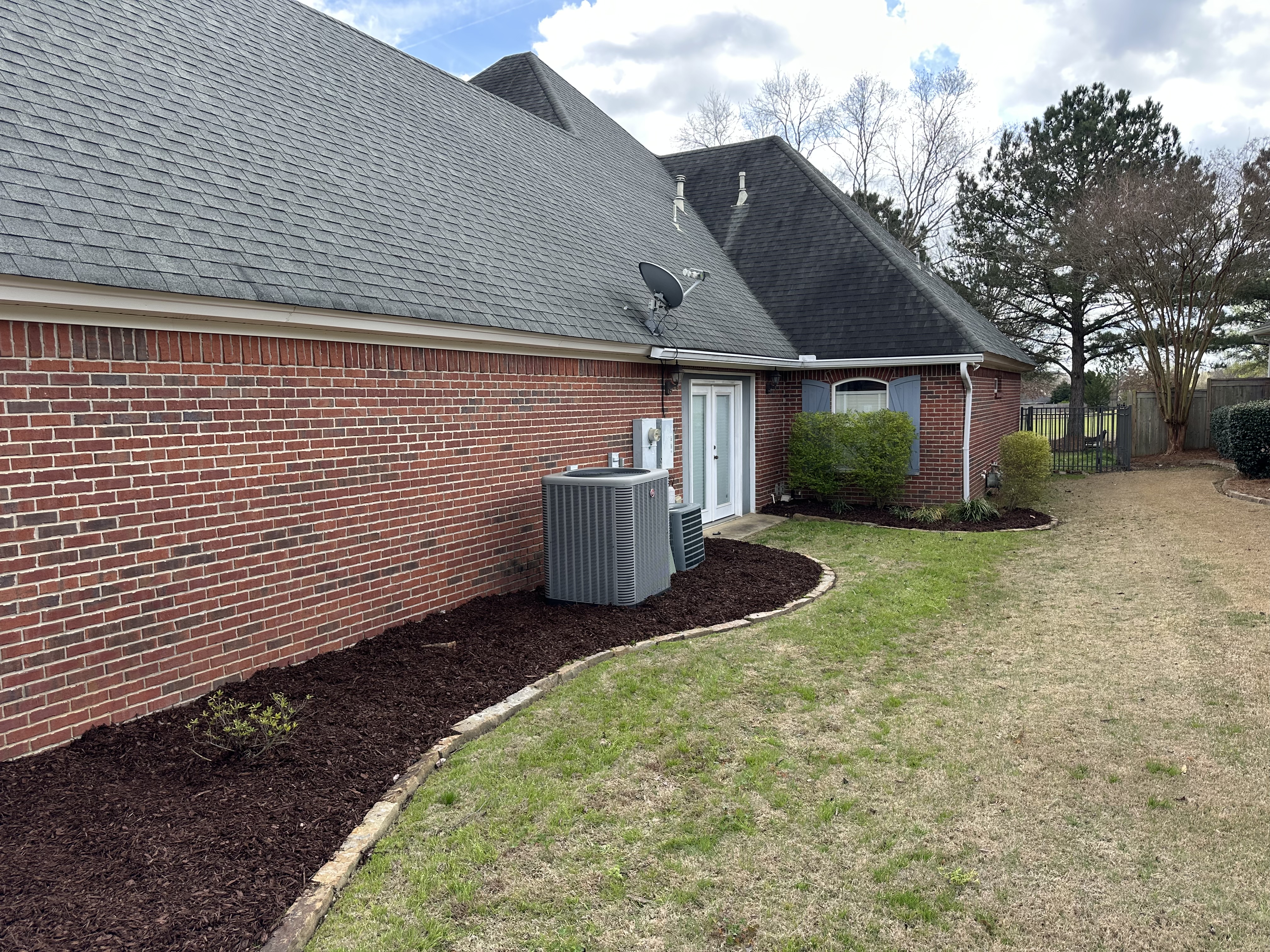 Brick home with curbed mulched beds